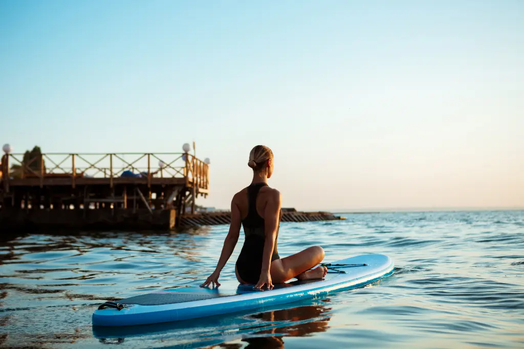 silhouette-of-beautiful-woman-practicing-yoga-on-surfboard-at-sunrise.jpg